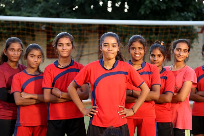 AJMER , RAJASTHAN, INDIA - OCTOBER, 02, 2022: Payal Prajapati, 18, (C) who was married at the age of nine, pictured with her team members at a stadium in Makadwali area in Ajmer district of Rajasthan, India